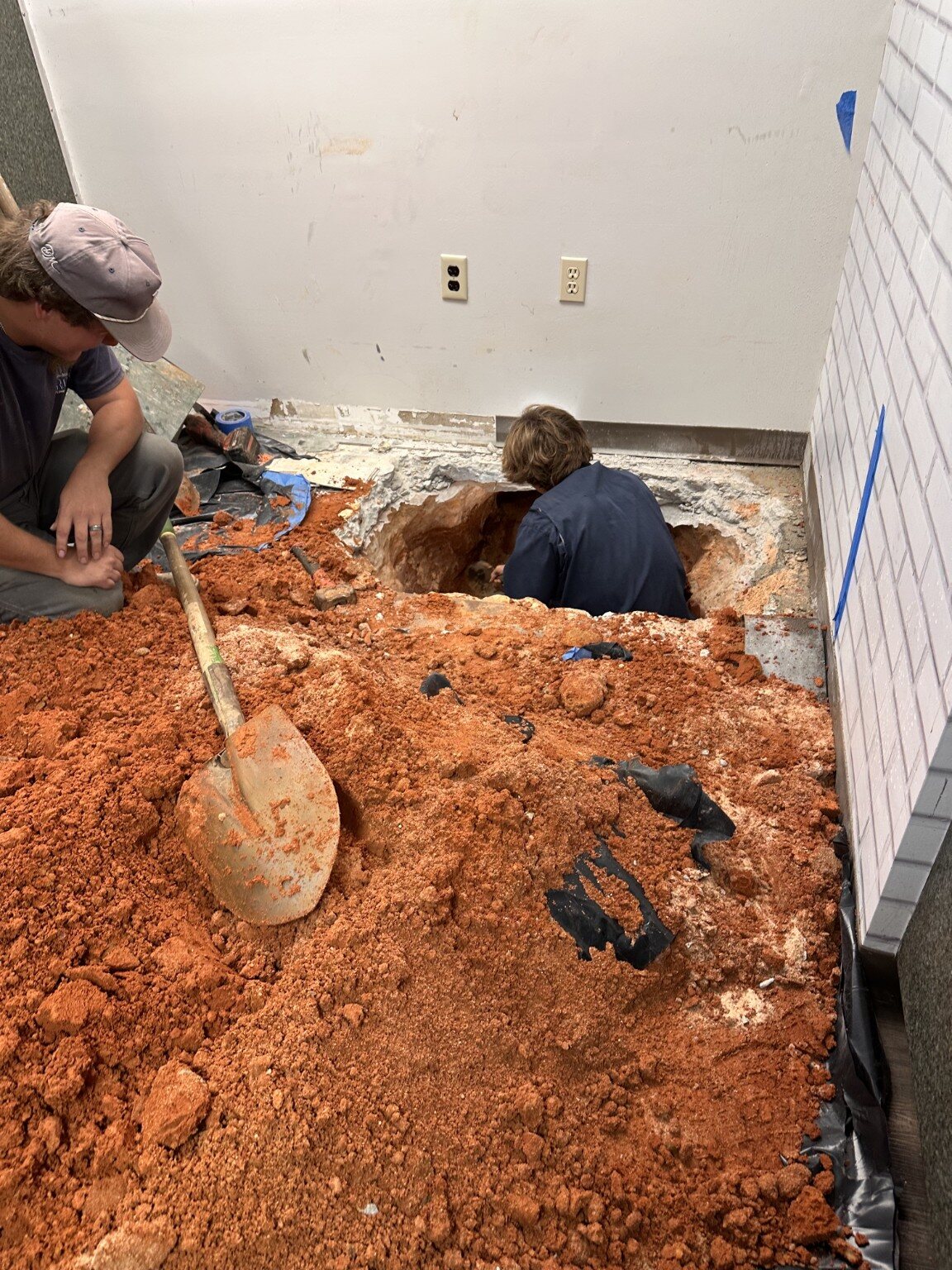 Quick Rooter plumbing crew excavating beneath a concrete slab